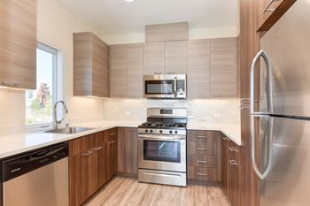 Kitchen with hardwood inspired floors and stainless steel appliances